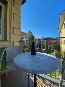 two wine glasses sitting on a table on a balcony at Clelia Apartments - Deiva Marina in Deiva Marina