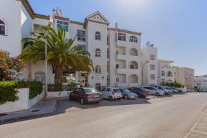 a row of cars parked in front of a building at Duas Palmeiras by LovelyStay in Albufeira
