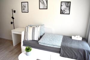 a small bedroom with a bed and a desk at Seifert Residence in Prague