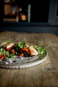 a plate of food on a wooden table at The George Hotel in Kirton in Lindsey