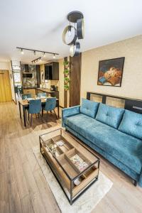 uma sala de estar com um sofá azul e uma mesa em Apartament Kilińskiego 17a,2 em Szklarska Poręba