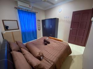 a bedroom with a bed and a couch and a door at Homestay Kimanis Papar in Kimanis