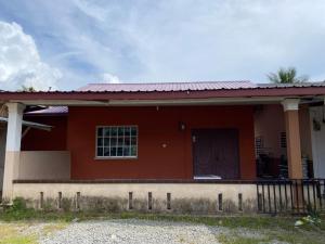 a red house with a fence in front of it at Homestay Kimanis Papar in Kimanis