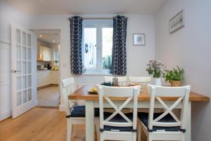 a kitchen and dining room with a table and chairs at Shell Cottage in Sidmouth