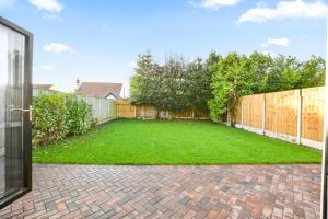 a backyard with a fence and a grass yard at Luxury 3-Bedroom House In Formby in Formby