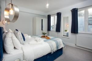 a bedroom with a large bed with towels on it at Shell Cottage in Sidmouth