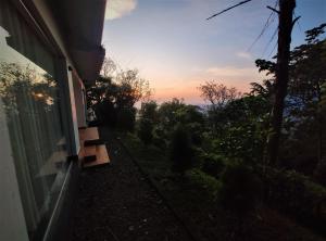 a view of the sunset from the side of a house at Peakaavu Cottages in Idukki