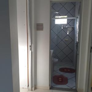 a bathroom with a shower with a glass door at casa de praia in Navegantes