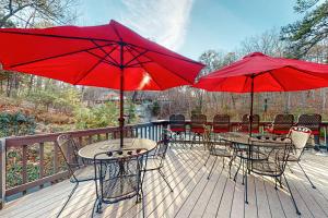 a deck with tables and chairs with red umbrellas at Bella Paradiso 04 in Eureka Springs