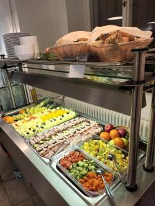 a buffet line with many different fruits and vegetables at Opitzův dům in Prague