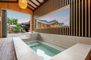 uma piscina no meio de uma casa em Elon Hanok Pension em Yeosu