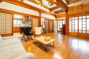 a living room with a couch and a coffee table at Elon Hanok Pension in Yeosu