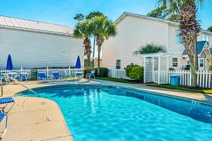 a swimming pool in front of a house at Summer Lake Townhomes 1 in Destin