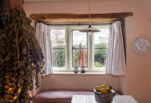 a window in a room with a bowl of fruit at Charming 2BD Cottage in the Heart of Kingham! in Kingham