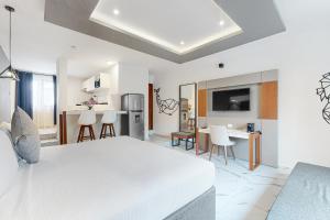 a white room with a kitchen and a living room at Seven Boutique Unit #36 in Cancún