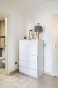 a white chest of drawers in a white room at Home2Book Comfy Apartment Rambla in Las Palmas de Gran Canaria