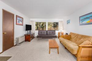a living room with a couch and a table at Skiview #103 in Girdwood