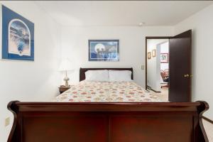 a bedroom with a large bed with a wooden frame at Skiview #103 in Girdwood