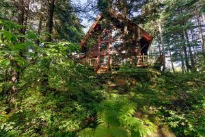 a tree house on a hill in the woods at Vail Chalet in Girdwood
