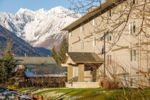 a building with a snow covered mountain in the background at Skiview #103 in Girdwood
