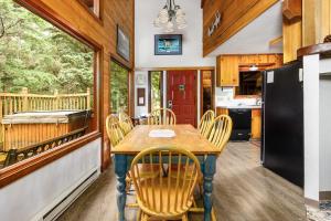 a dining room and kitchen with a table and chairs at Vail Chalet in Girdwood