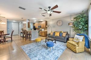 a living room with a couch and a table at 15 Mi to Disney Kissimmee Townhome with Patio in Kissimmee