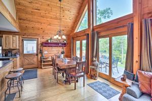 a dining room and kitchen in a log home at Lakefront Athens Getaway with Game Room and Deck! in Athens