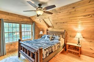 a bedroom with a bed and a ceiling fan at Lakefront Athens Getaway with Game Room and Deck! in Athens