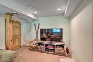 a living room with a flat screen tv on a wall at Lakefront Athens Getaway with Game Room and Deck! in Athens