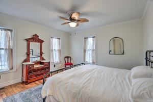 a bedroom with a bed and a ceiling fan at Walkable Sodus Point Retreat Less Than 1 Mi to Lake in Sodus