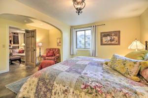 a bedroom with a bed and a living room at Charming Cody Home, Walk to Downtown! in Cody