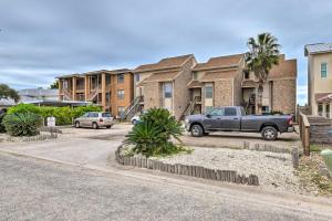 a truck parked in a parking lot in front of condos at Boat Slip Access North Padre Island Condo! in Padre Island