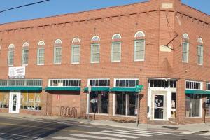 a large red brick building on a street corner at Riverfront Loft Apt A in Salisbury
