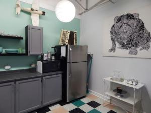 a kitchen with a refrigerator and a picture of a lion on the wall at Riverfront Loft Apt A in Salisbury