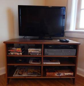 a wooden entertainment center with a flat screen television on it at Riverfront Loft Apt A in Salisbury