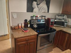 a kitchen with a stove and a counter top at Loft Apartment w River Views in Salisbury