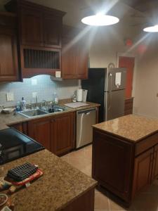 een keuken met houten kasten en een roestvrijstalen koelkast bij Loft Apartment w River Views in Salisbury