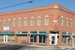 a large red brick building on a street corner at Loft Apartment w River Views in Salisbury