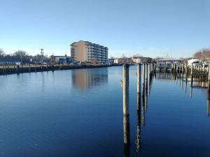 a body of water with poles in the water at Corner loft with river views in Salisbury