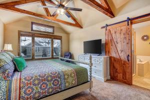 a bedroom with a bed and a flat screen tv at 4 Bed 4 Bath Vacation home in Oaks at Wasatch in Cottonwood Heights