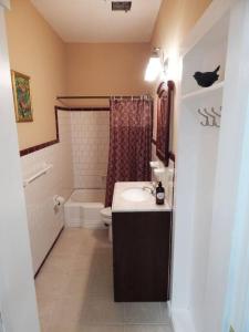 a bathroom with a sink and a toilet and a tub at 2 bed, 1 bath riverfront loft in Salisbury