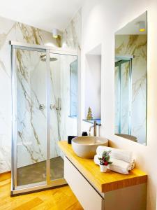 a bathroom with a sink and a shower at Agrigento Boutique Apartments in Agrigento