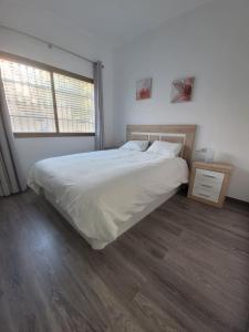 a bedroom with a large bed and a window at Bajo,Puebla Lucia,Fuengirola in Fuengirola