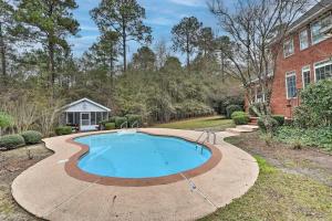 a swimming pool in a yard next to a building at Spacious Statesboro House with Private Pool! in Statesboro