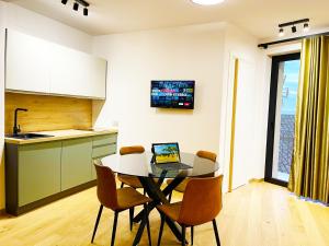 a kitchen and dining room with a table with a laptop on it at Agrigento Boutique Apartments in Agrigento