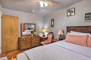 a bedroom with a bed and a dresser and a mirror at Family-Friendly Birmingham Home 3 Mi to Dtwn in Birmingham