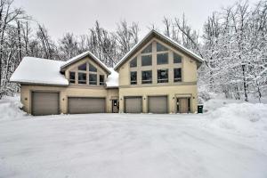 une maison dans la neige avec une allée dans l'établissement Spacious and Secluded Home by Pokegama Lake!, à Grand Rapids