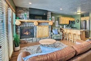 a living room with a couch and a fireplace at Cozy Eden Condo with Mtn Views in Wolf Creek Resort! in Eden