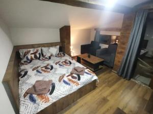 a bedroom with a bed with towels on it at Villa ANA-Mavrovo in Mavrovo
