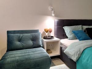 a bedroom with a couch and a bed and a table at Modern Courtyard Condo in Liepāja +11 photos